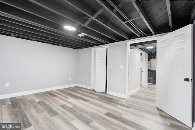 finished below grade area featuring light wood-type flooring and baseboards