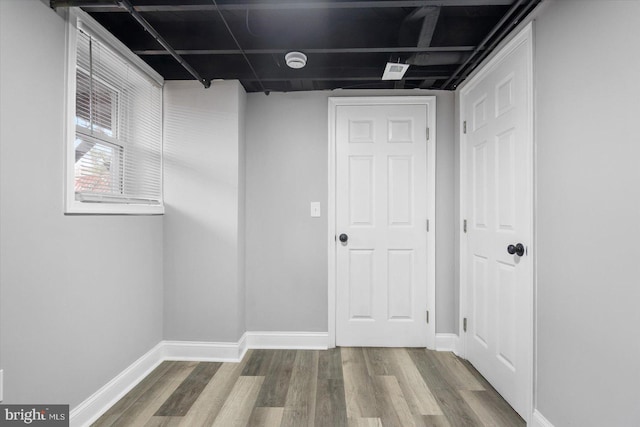 interior space with wood finished floors and baseboards