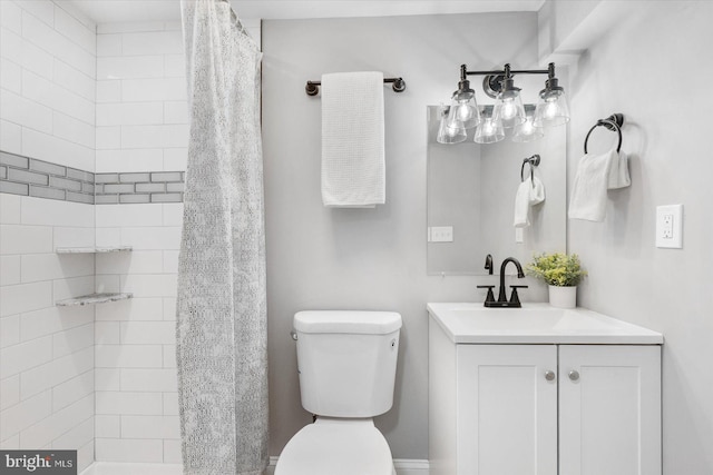 full bathroom with toilet, tiled shower, and vanity