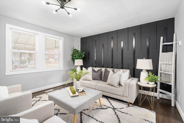 living area featuring wood finished floors, visible vents, and baseboards