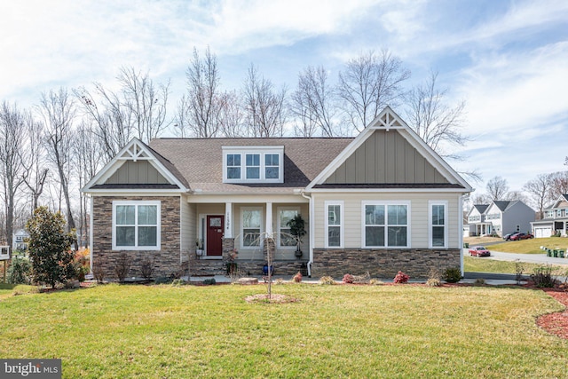 craftsman-style home with stone siding, board and batten siding, and a front lawn