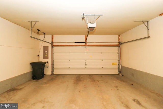 garage featuring electric panel and a garage door opener