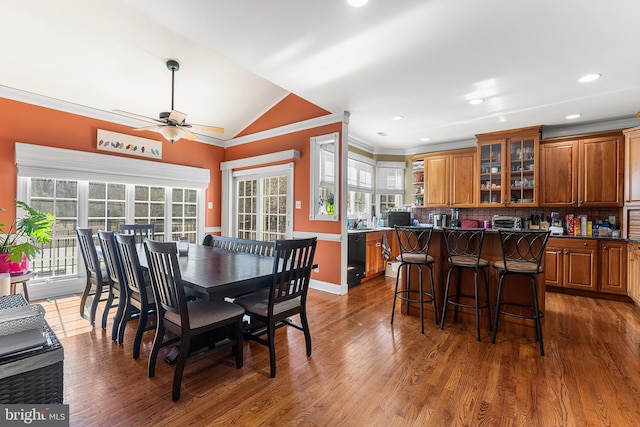 dining space featuring ceiling fan, wood finished floors, crown molding, and vaulted ceiling