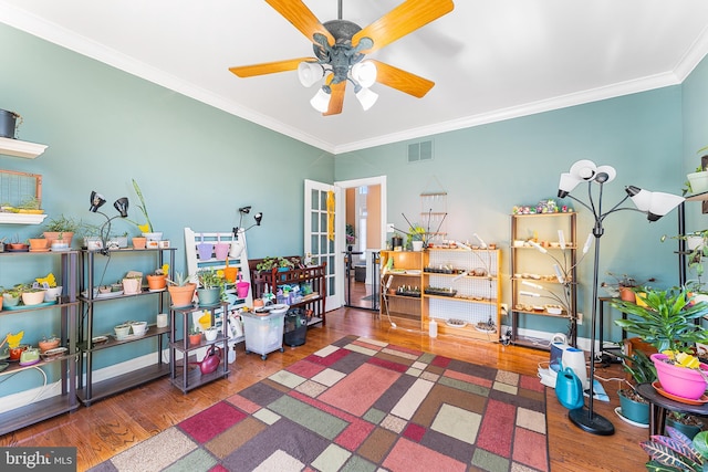 rec room with visible vents, ornamental molding, wood finished floors, french doors, and ceiling fan