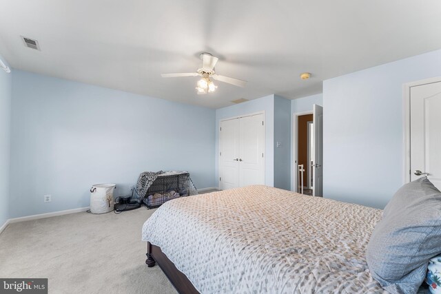 bedroom featuring visible vents, a closet, carpet, baseboards, and ceiling fan