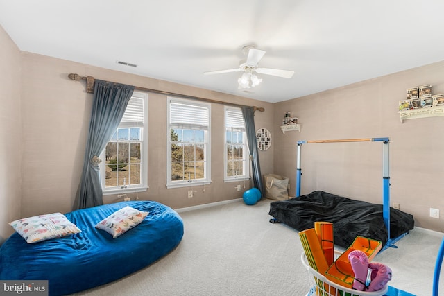 carpeted bedroom featuring visible vents, baseboards, and a ceiling fan