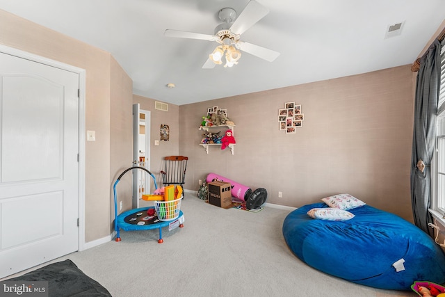 carpeted bedroom featuring a ceiling fan, baseboards, and visible vents