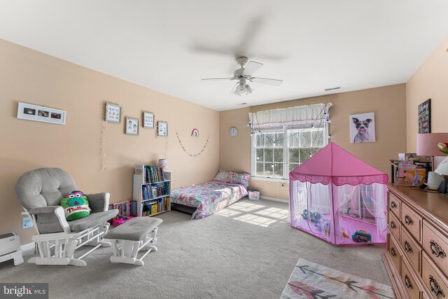 carpeted bedroom featuring visible vents and a ceiling fan