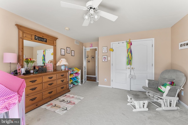 interior space with light carpet, visible vents, a ceiling fan, and baseboards