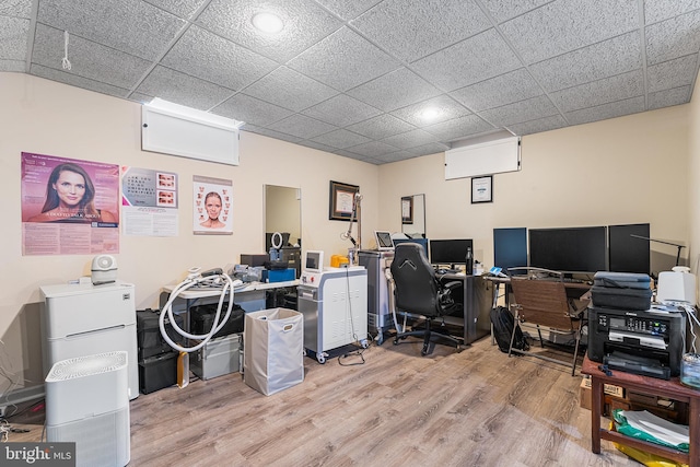 office featuring a drop ceiling and light wood-type flooring