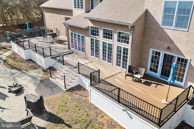 wooden deck with outdoor dining area and fence