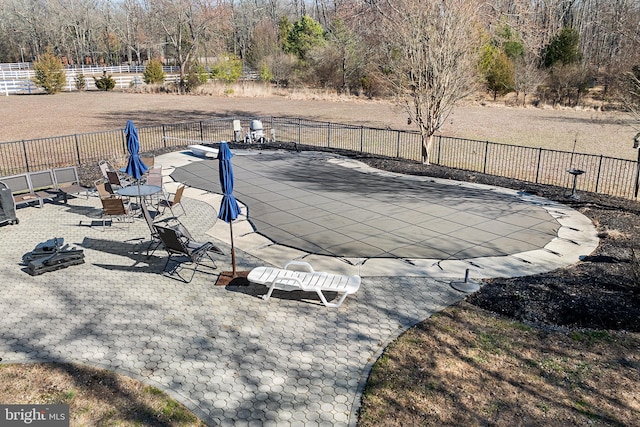 view of swimming pool with a patio area, fence, and a fenced in pool