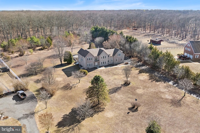 drone / aerial view with a wooded view