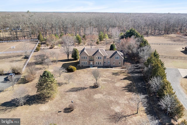 drone / aerial view with a wooded view