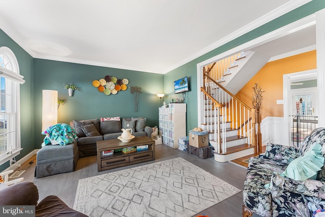 living room with stairs, crown molding, and wood finished floors