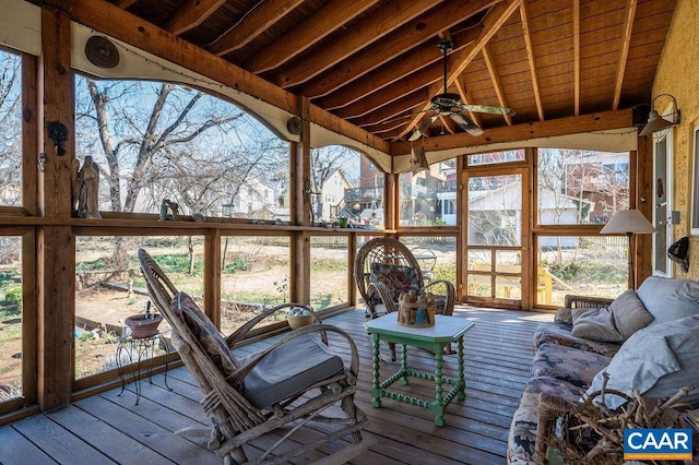 unfurnished sunroom with vaulted ceiling with beams and a ceiling fan