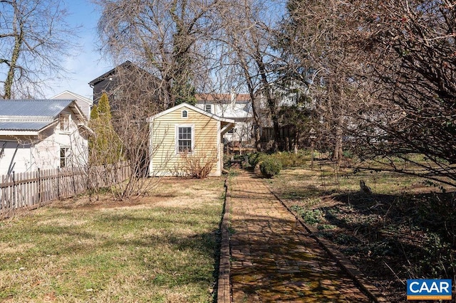 view of yard featuring an outdoor structure and fence