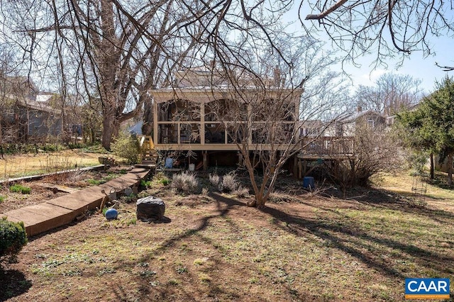 rear view of house featuring a sunroom