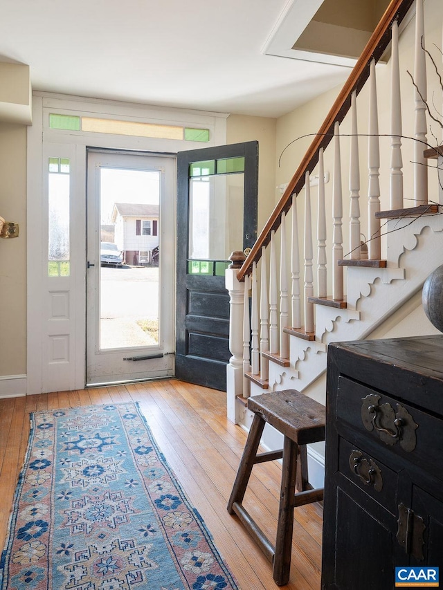 entrance foyer featuring stairway and hardwood / wood-style flooring