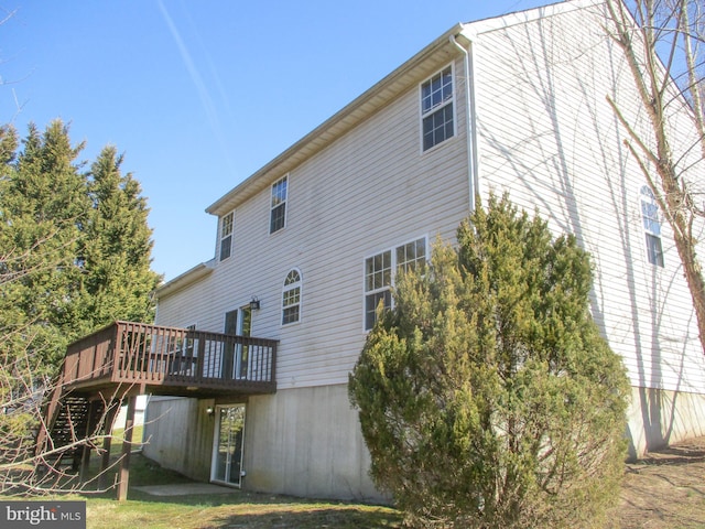 back of house featuring a wooden deck