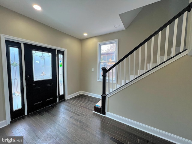 foyer entrance with stairway, recessed lighting, baseboards, and dark wood-style flooring