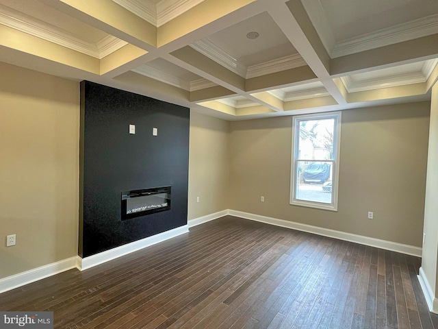 below grade area with a glass covered fireplace, crown molding, dark wood-style floors, and baseboards