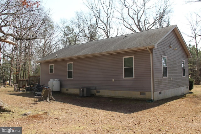 view of home's exterior featuring crawl space, central AC unit, and a shingled roof