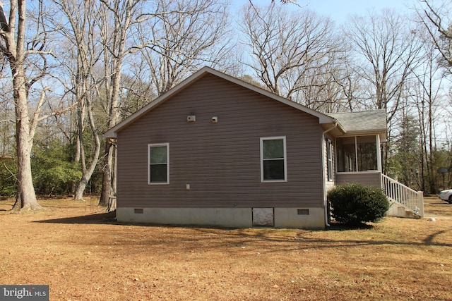 view of home's exterior featuring crawl space, a yard, a shingled roof, and a sunroom