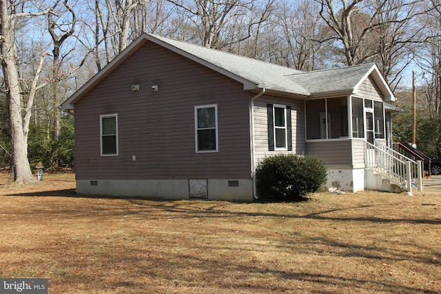 view of home's exterior with roof with shingles, a yard, a sunroom, and crawl space