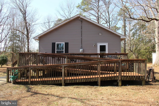 back of house with a wooden deck