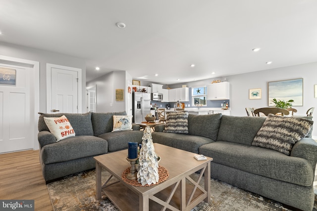 living room with recessed lighting and light wood-style floors