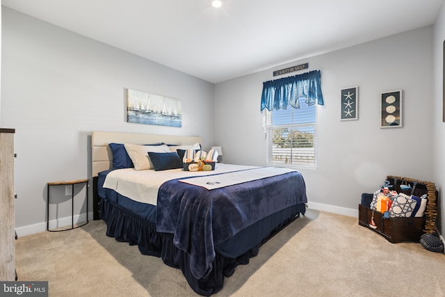 bedroom featuring carpet floors and baseboards