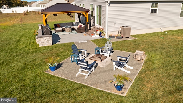 view of patio / terrace with entry steps, central AC, outdoor lounge area, fence, and a gazebo