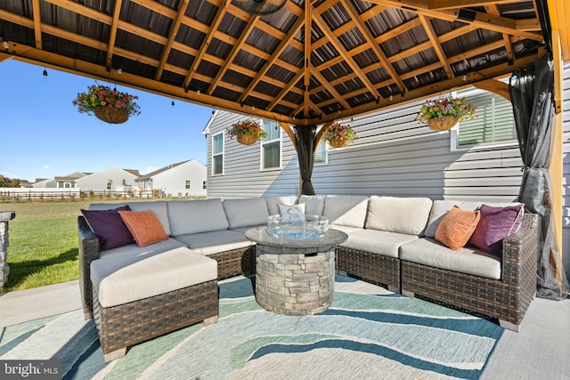 view of patio with a gazebo, fence, and an outdoor living space