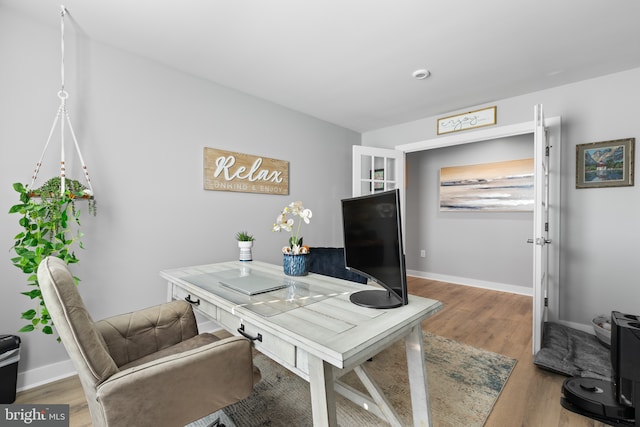 office featuring baseboards and wood finished floors