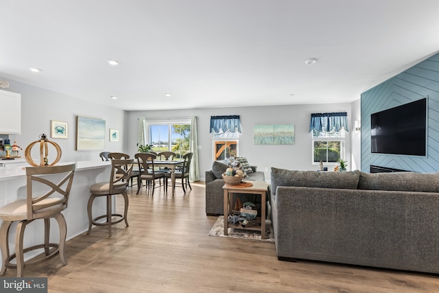 living area with light wood-style flooring and recessed lighting