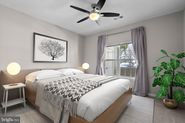 bedroom featuring carpet floors, baseboards, visible vents, and a ceiling fan