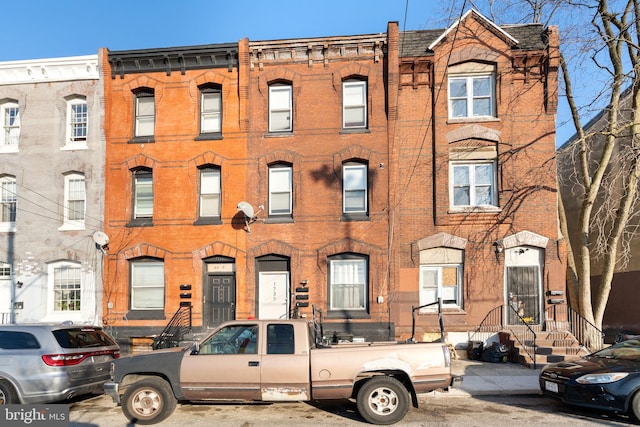 townhome / multi-family property with brick siding