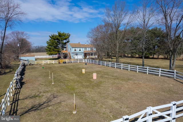 view of yard featuring a rural view and fence