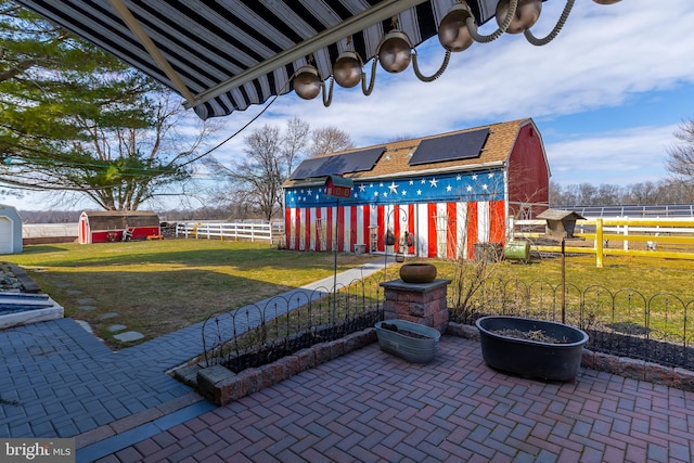 view of patio featuring an outdoor structure, a storage unit, and fence