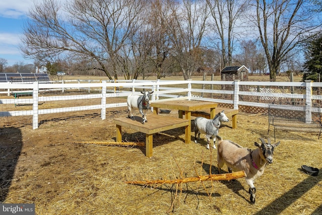 view of yard featuring a rural view and fence