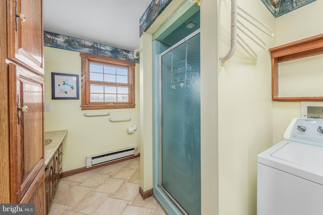 interior space featuring a shower stall, a baseboard heating unit, baseboards, washer / clothes dryer, and vanity