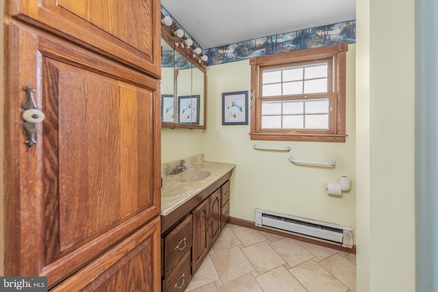 bathroom with baseboards, baseboard heating, vanity, and tile patterned flooring