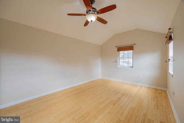 unfurnished room with a ceiling fan, baseboards, vaulted ceiling, and wood finished floors