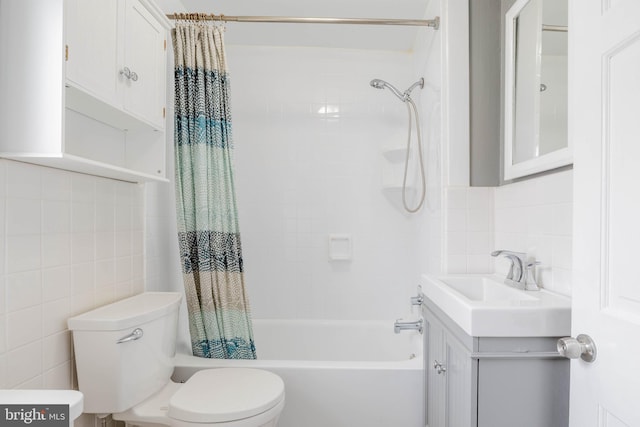 bathroom with tasteful backsplash, toilet, shower / bath combination with curtain, vanity, and tile walls