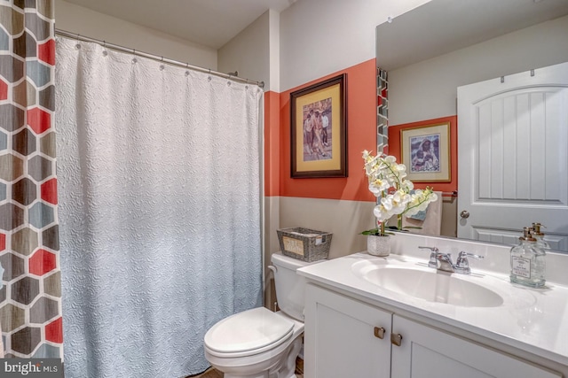 bathroom featuring toilet and vanity