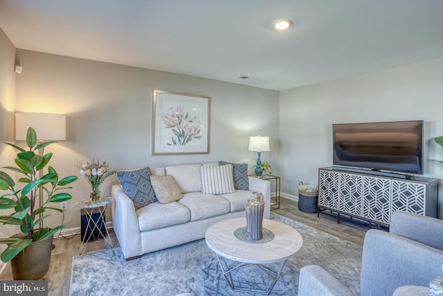 living area featuring wood finished floors and baseboards