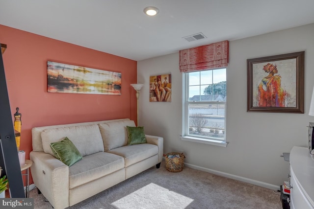 carpeted living room with visible vents and baseboards