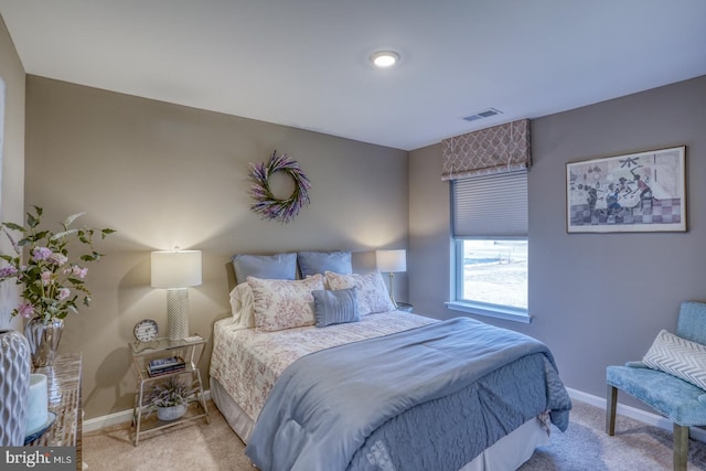 bedroom with carpet floors, visible vents, and baseboards