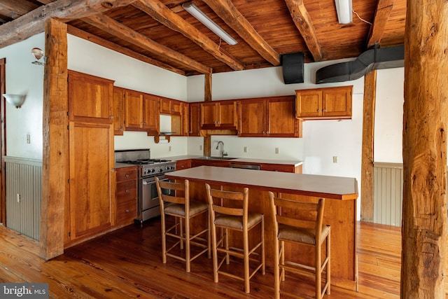 kitchen with wooden ceiling, brown cabinets, dark wood-type flooring, beamed ceiling, and stainless steel appliances